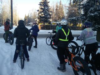 Group riding mountain bikes in snow.