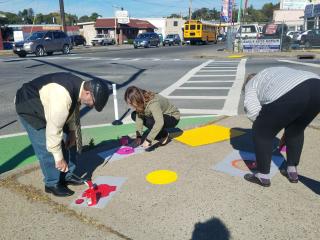 Painting polka dots on sidewalk