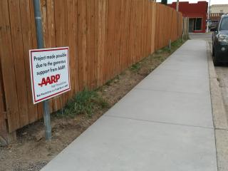 New sidewalk with sign.