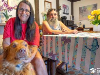 Couple and dog helped by home repairs.