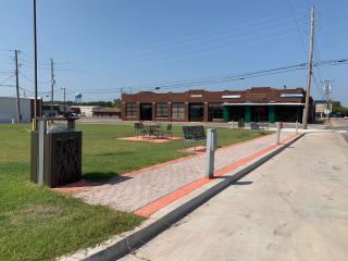 After construction with grass, tables, and parking with electricity for food trucks.