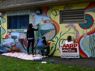 Volunteers painting mural.