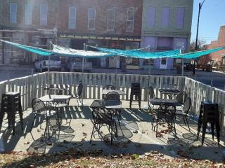 Parklet with seating and shade covers.