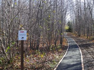 Completed crushed gravel trail with sign.