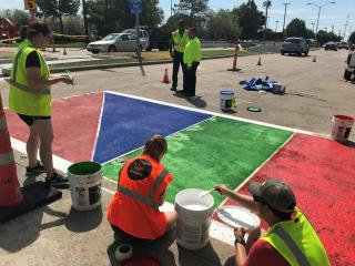 Painting colorful crosswalk.