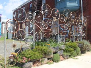 Bicycle art on fence.