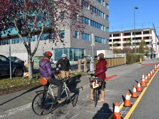 Group riding bike along pop-up protected bike lane.