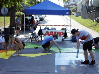 Volunteers painting intersection.
