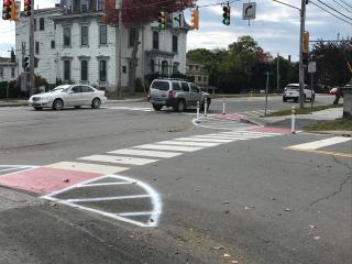 Newly painted crosswalk with lane delineators.
