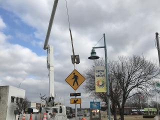 Installing new automatic crosswalk light.