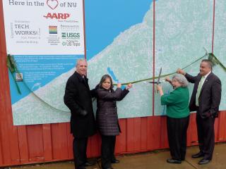 Group cutting ribbon for map.