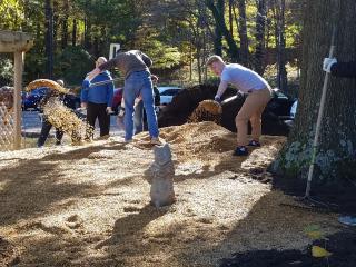 Group spreading mulch and gravel.