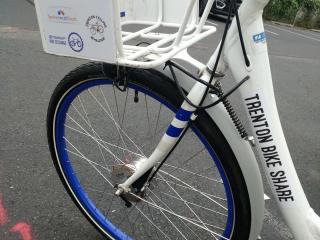 Close of of bike with AARP logo on basket.