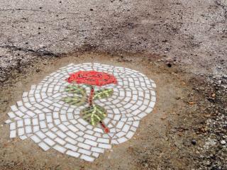 Mosaic art in pothole.