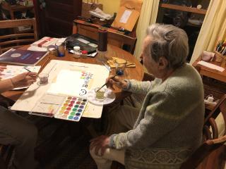 Older adult using art supplies.