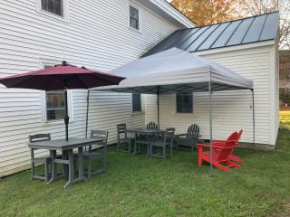 Outdoor seating, tables, and umbrella.