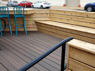 Parklet with bench and bar style seating.