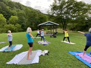 Yoga in the park by pavilion.