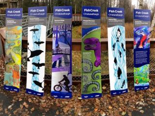 Six artistic trail signs for Fish Creek Ch'atanaltsegh.