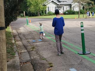 Parent and child walking along pop-up trail.