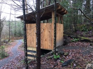 Accessible privy toilet along accessible trail.