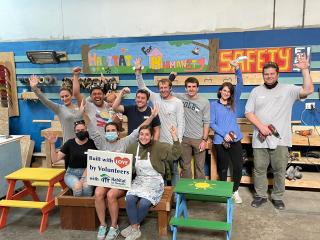 Volunteers helping in work shop building benches, tables, and garden beds.