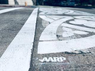 Closeup of crosswalk with AARP acknowledgement.