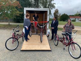 Ribbon cutting for trailer and tricycles.