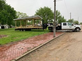 New picnic shelter and picnic benches delivered to park.