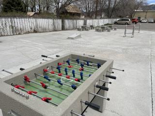 Outdoor concrete foosball table and cornhole game