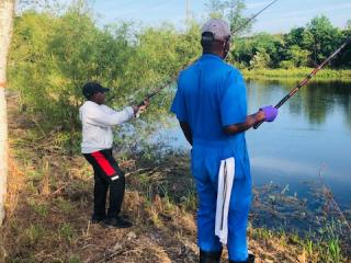Older adult and child fishing.
