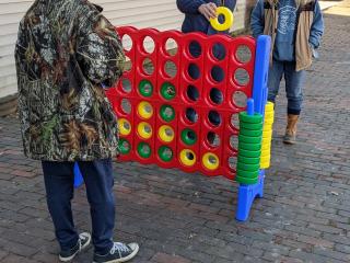 Large Connect Four game being played.