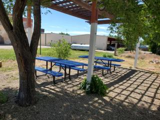 Two new picnic tables under pergola.
