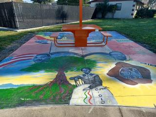 Mural painted on concrete under solar charging table.