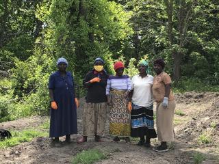 Five women refugee community farmers.