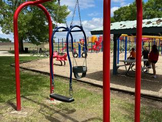 Swing for both adult and toddle at playground.