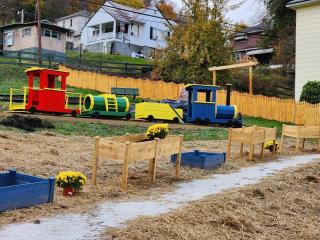 Play train, planters, and new fence for park.