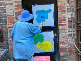 Painting alley doors.