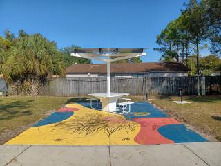 Second solar charging table and mural.