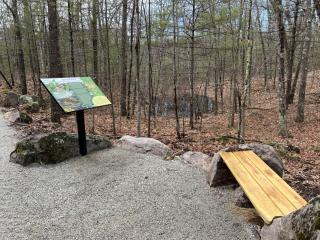 All Person Trail bench and interpretive panel.