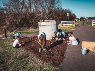Girl scouts planting along Museum Trail.