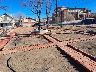 New garden laid out with brickwalkway.