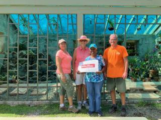 Volunteers in front of renovated greenhouse.