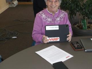 Older adult using senior center tablet.