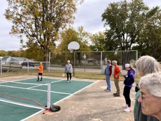 Older adults playing pickleball.