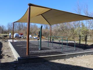 Shade structure over fitness equipment.