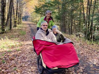 Trishaw with riders under a blanket seeing fall colors.