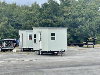 Two tiny homes on trailers.