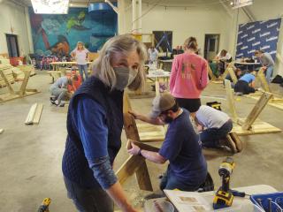 Volunteers building benches and tables.