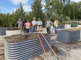 Volunteers installing raised garden beds.